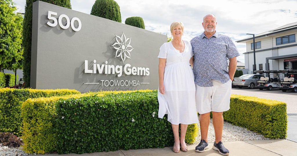Resort managers standing in front of Living Gems Toowoomba sign