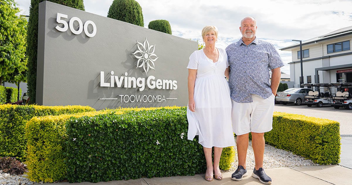 Resort managers standing in front of Living Gems Toowoomba sign