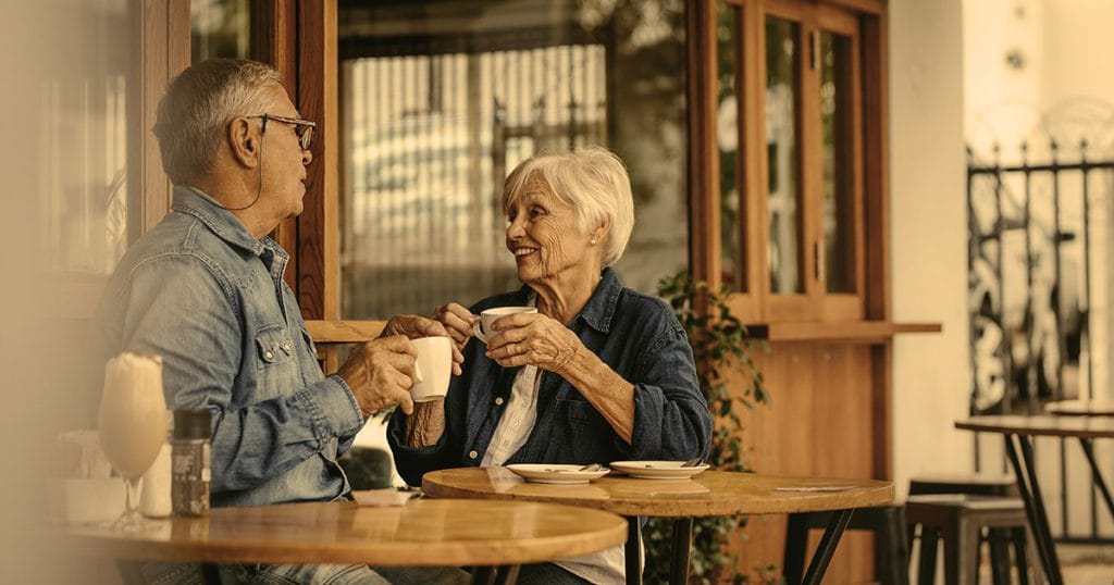 Over 50s couple drinking from their cups