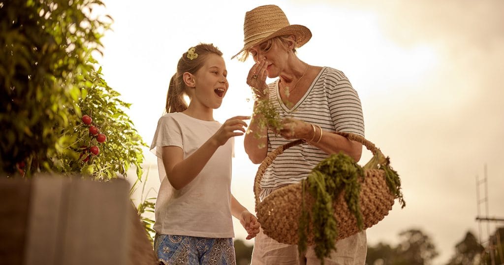 Grandparent with grandchild in the Caboolture vege garden