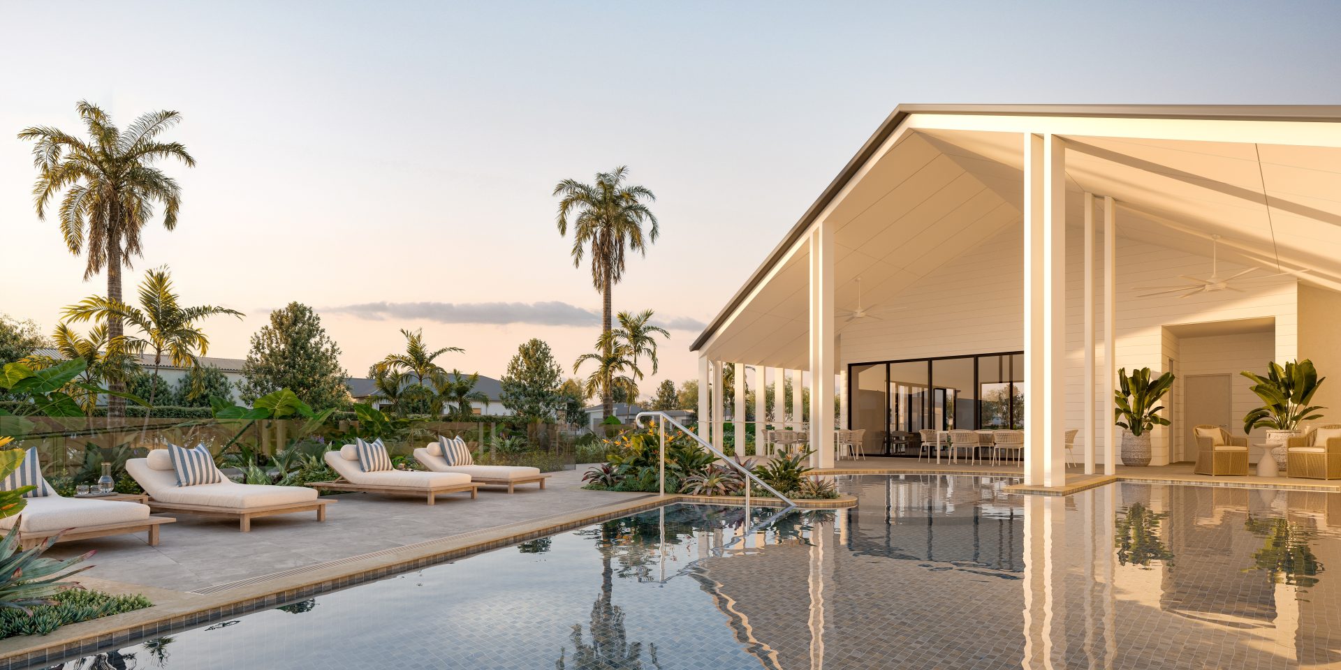 Resort-style swimming pool surrounded by sun lounges, tropical palm trees and landscaped gardens, beside a spacious, modern pavilion with covered outdoor seating.